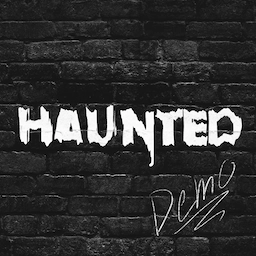 Cover art for Haunted. The text "Haunted" is painted in white on a black brick wall.